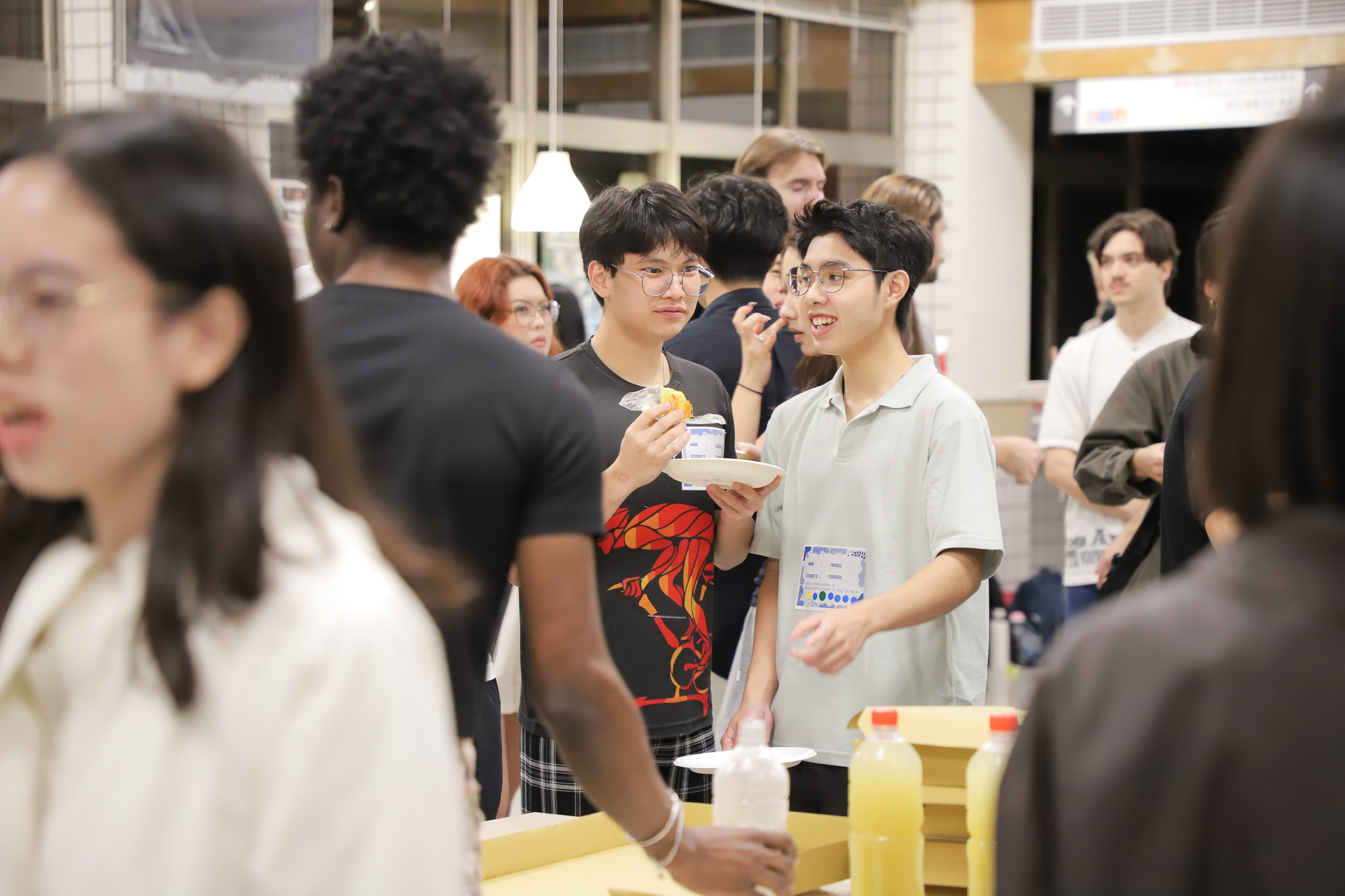 After the presentations, students freely enjoyed food in the atrium and mingled with peers from other groups. (Photo credit: ICI)