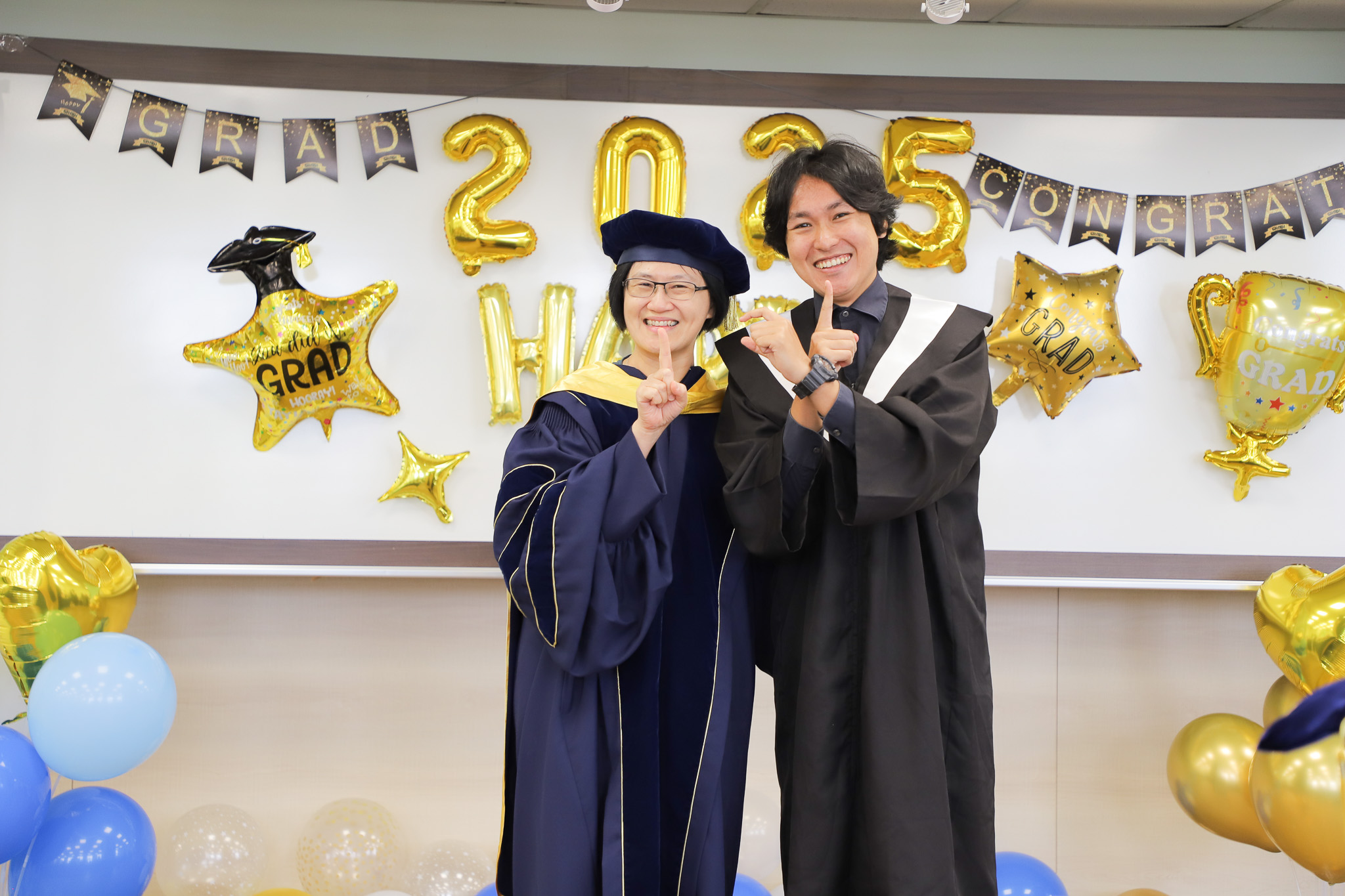 Dean Tu poses for a group photo with students during ICI's graduation celebration. (Photo by ICI)