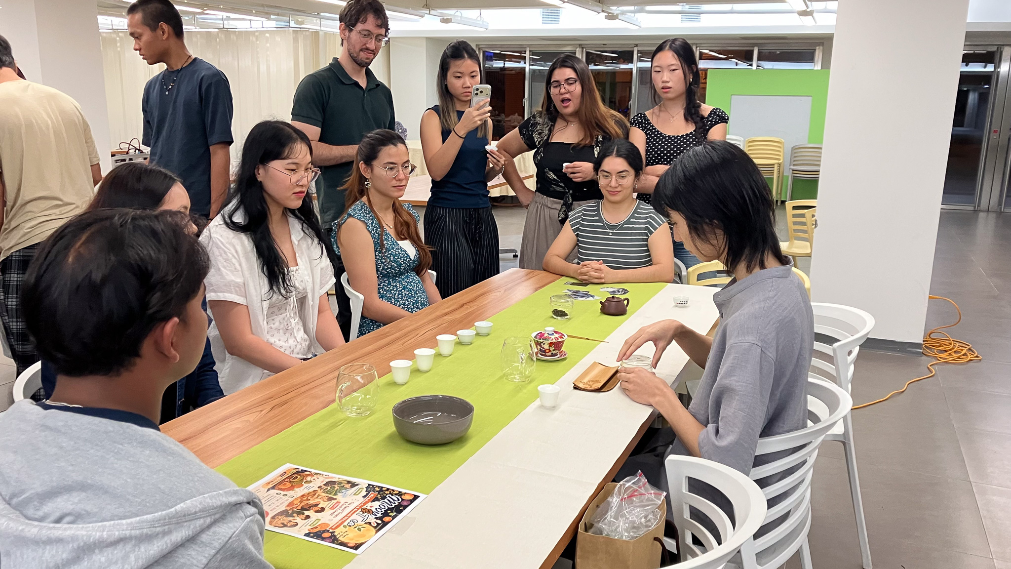 NCCU Tea Arts Club President Wilson (right) introduces Taiwanese tea culture through a tea ceremony and tasting.(Photo courtesy of ICI)