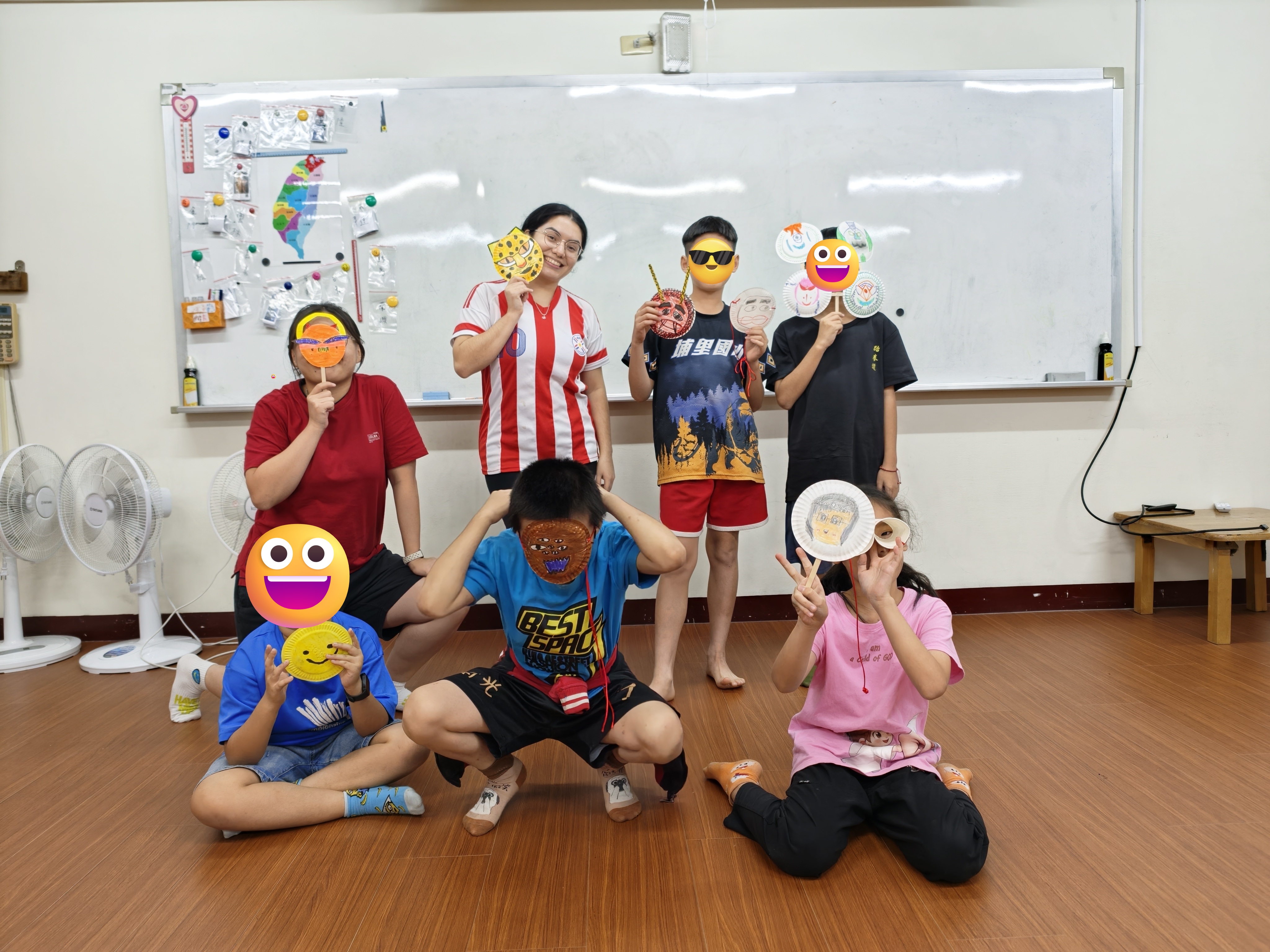 Kids and volunteers show-off the masks they designed and created during the second class of the program. (Source: Erinna Tania)